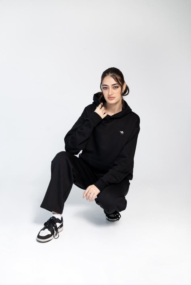 Person wearing a black outfit with a white background